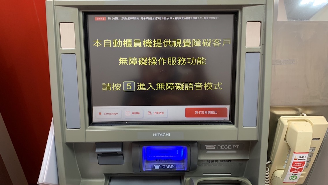 照片中的自動櫃員機（ATM）螢幕以文字提示「本自動櫃員機提供視覺障礙客戶 無障礙操作服務功能 請按5進入無障礙語音模式」。